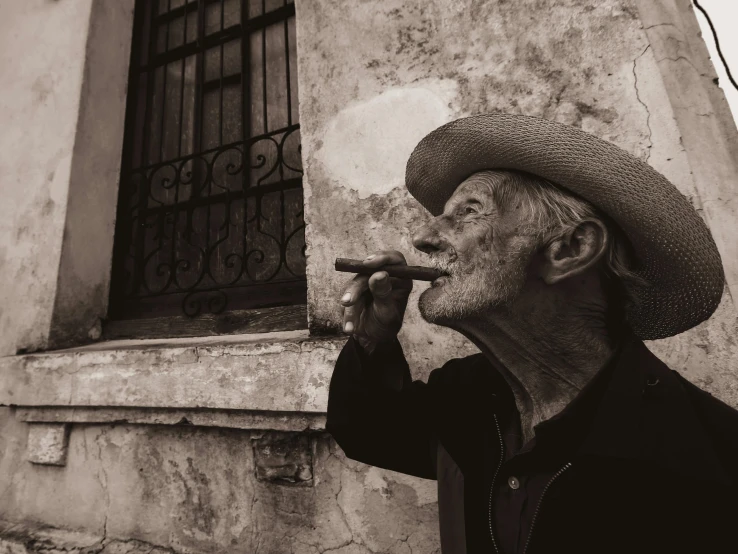 a man with a hat smoking a pipe