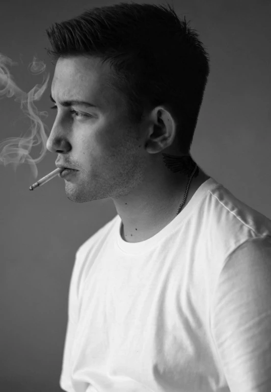 a man with smoke coming out of his mouth smoking a cigarette