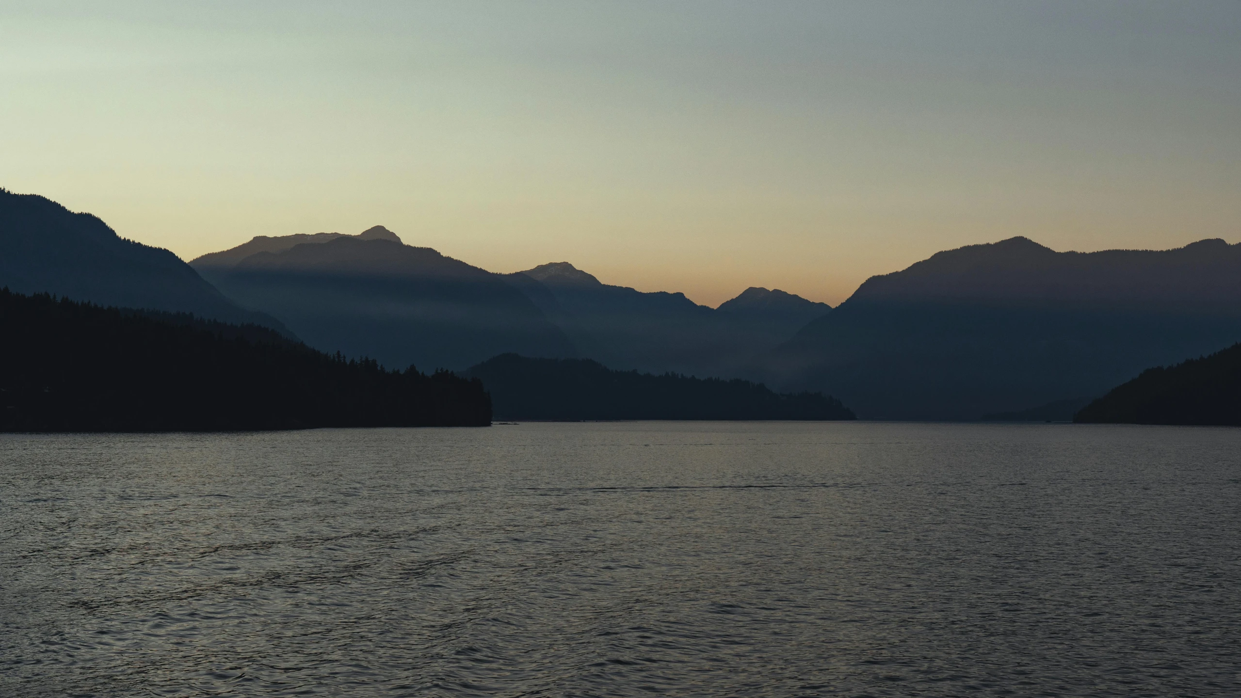 this is an image of a body of water with mountains in the background