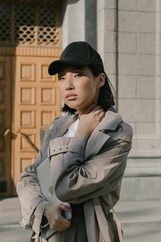 a woman with a black hat and trench coat