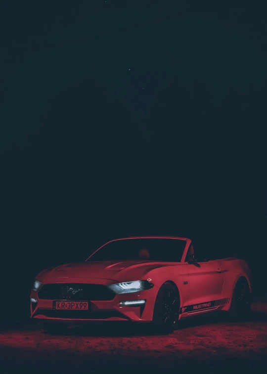 a car parked on the road in front of the dark night sky