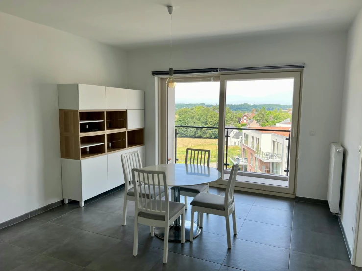 a table and chairs in a room with doors leading to a patio