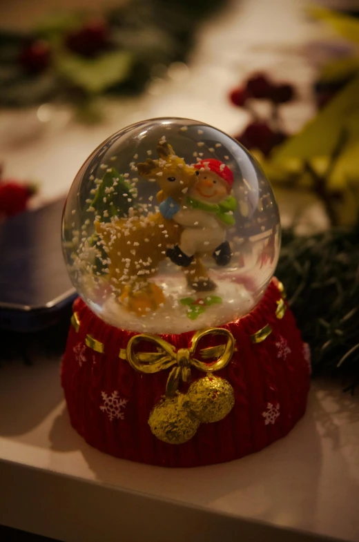 a snow globe with snowflakes and a bow