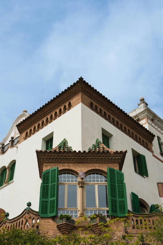 a house that has green shutters on the windows