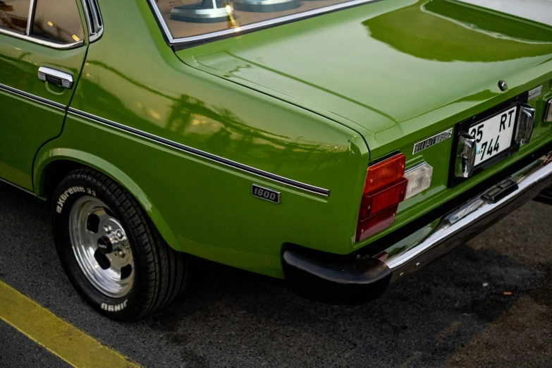 green car with a flat top and bumper down