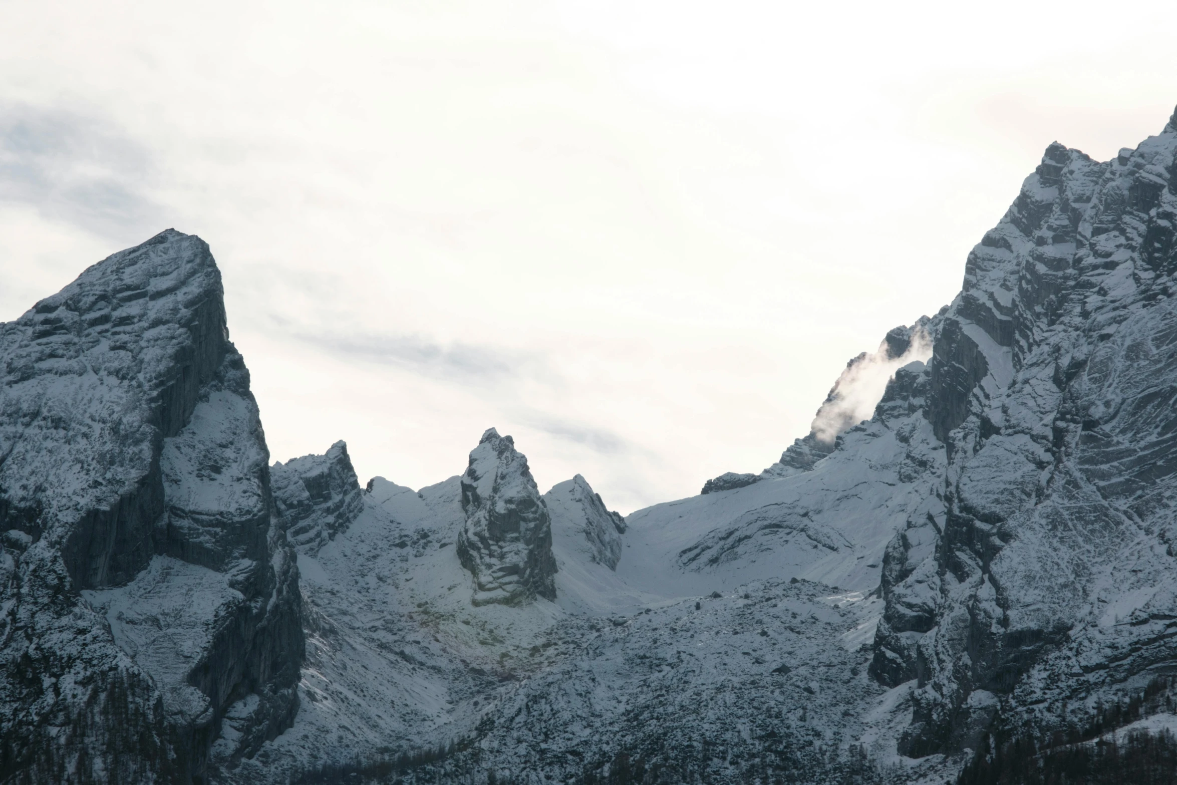 an aerial view of mountains covered in snow