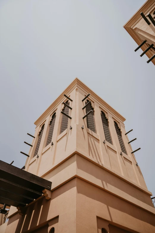 tall clock tower in tan tones with decorative windows