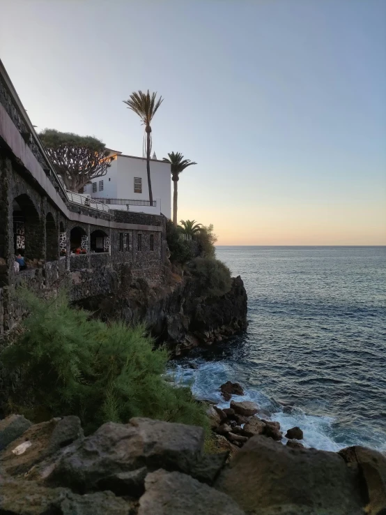 houses on a cliff next to the ocean