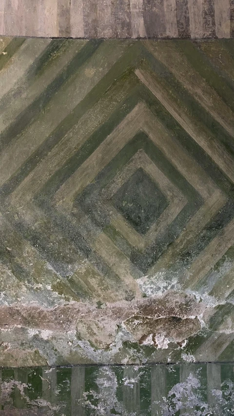 the reflection of a green street sign with a background of squares and lines