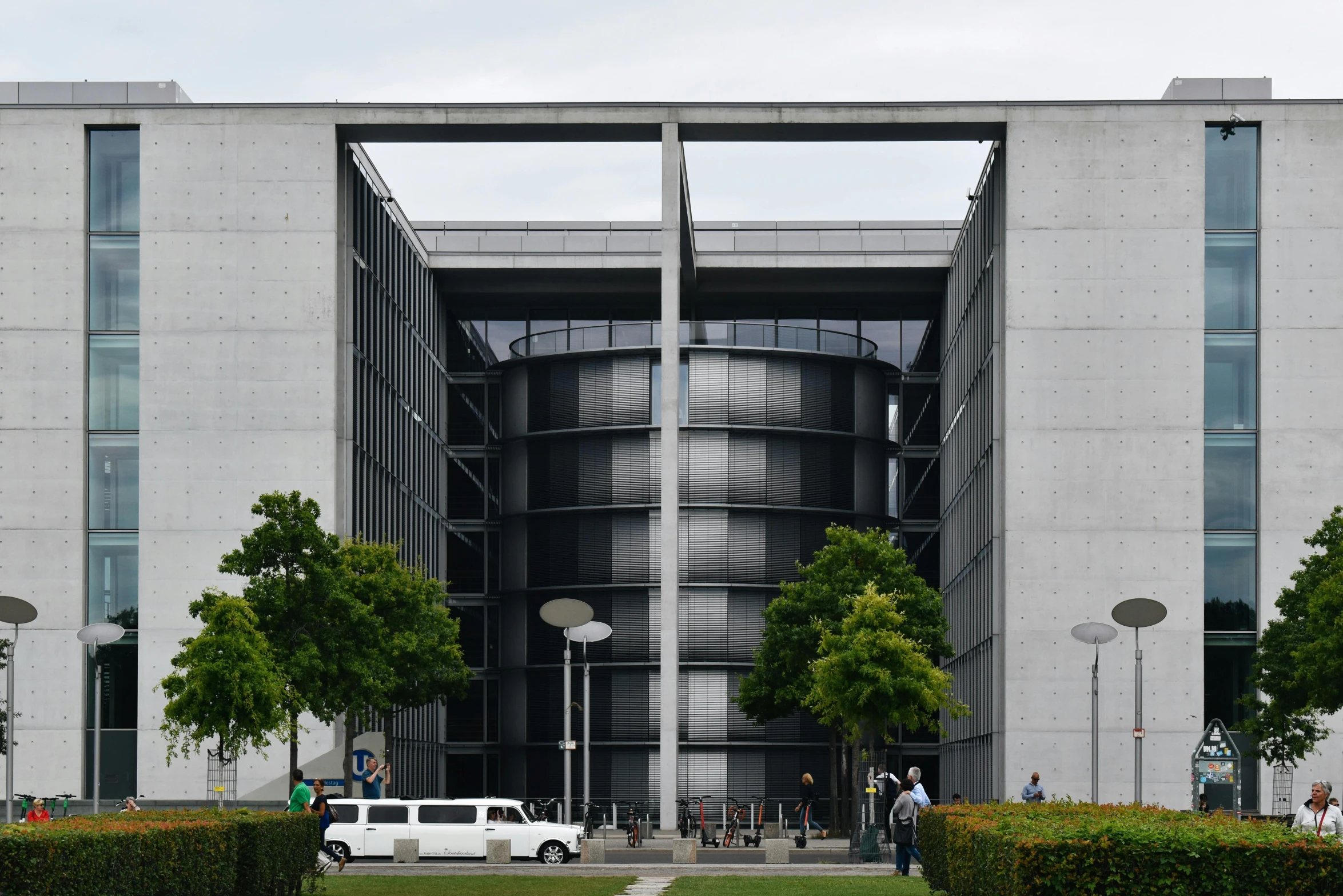 a large building is shown with many trees in front