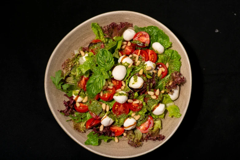 a salad sits in a bowl on a table