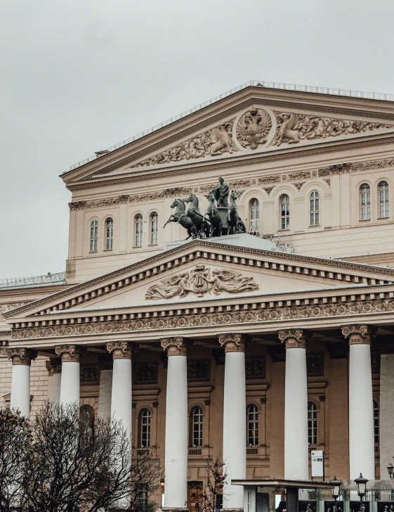 a large building with columns and a statue on the top