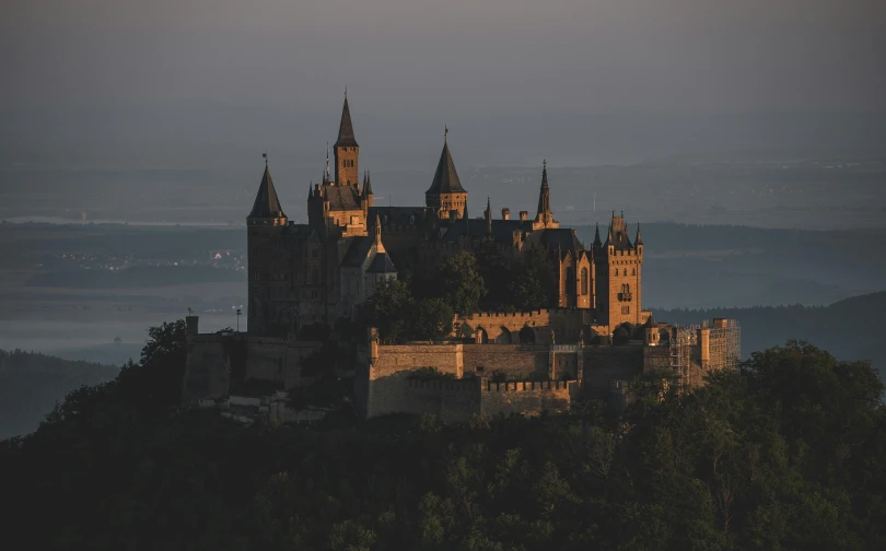 a castle like structure sits atop a hillside