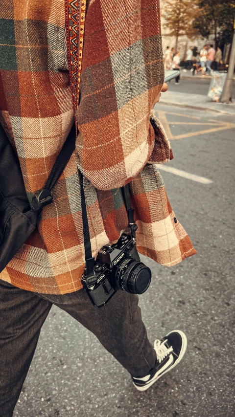 this is a man with a camera on a sidewalk