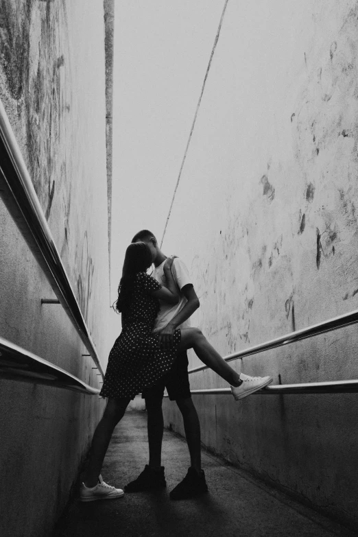 a woman sitting next to a man on top of a stair case