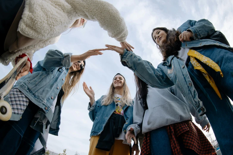 girls standing around with arms in the air