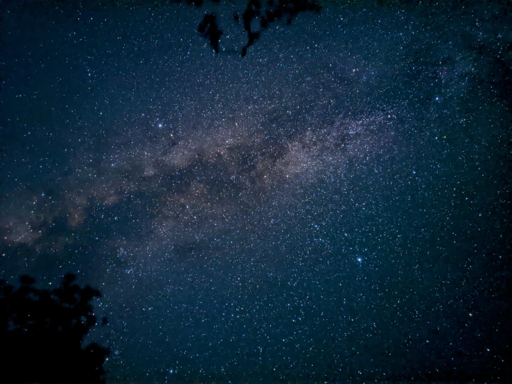 a night sky with the milky in the middle