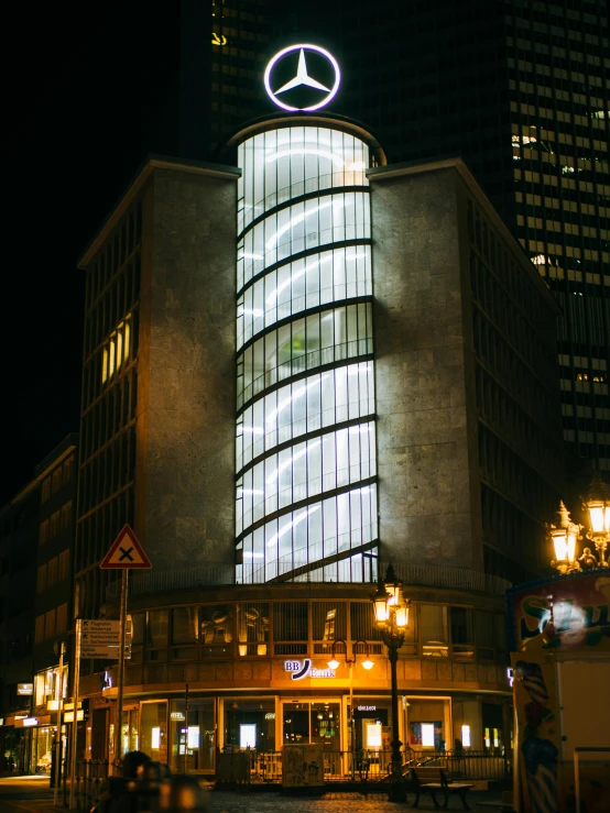 a tall building that has a lit up light above it