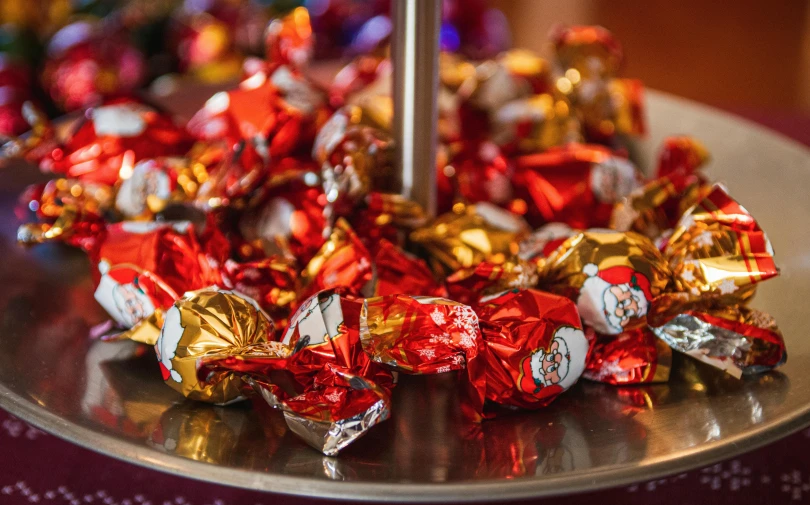 assorted candy bars are displayed in a silver display