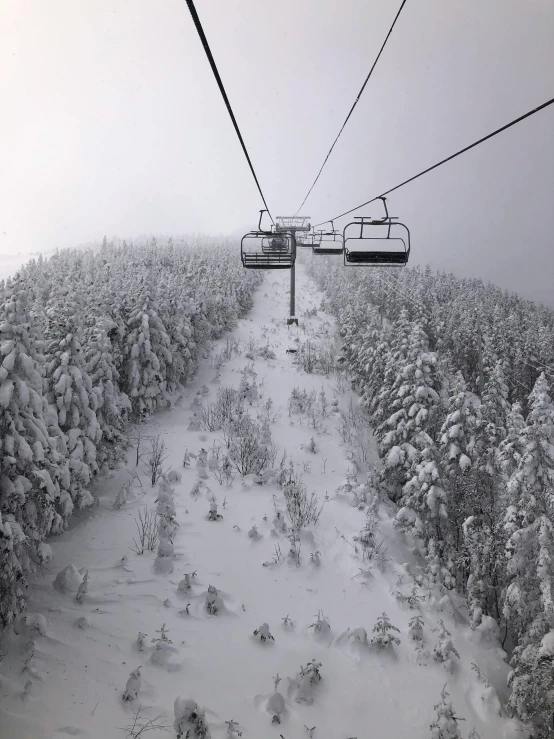 there is a ski lift over the snow - covered hills