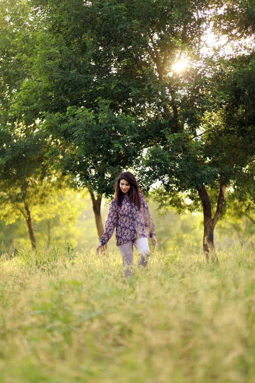 a girl in a grassy field holding an umbrella