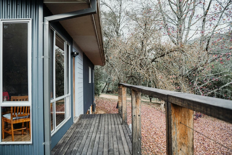 an empty patio with a table and chair on the deck