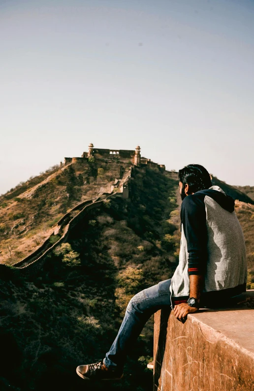 a person on the edge of a steep hill