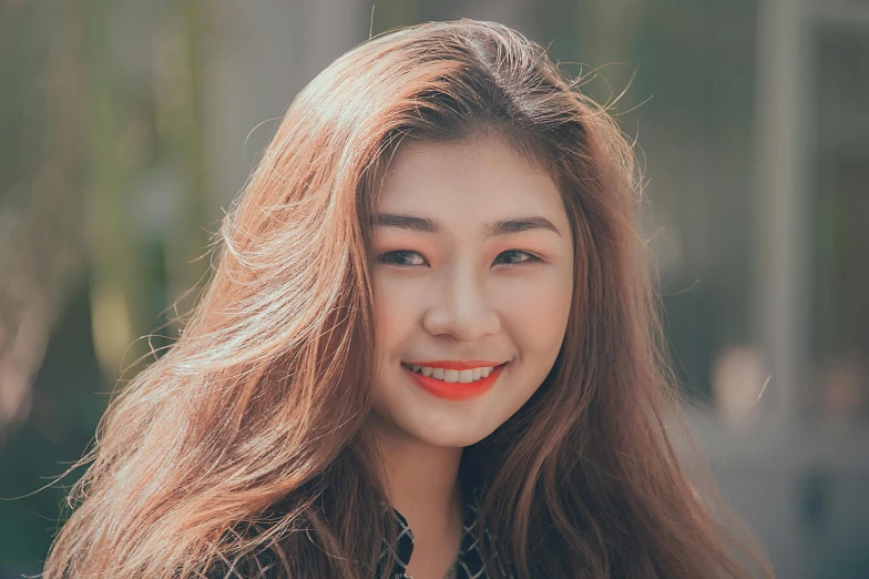 an asian woman with long wavy hair