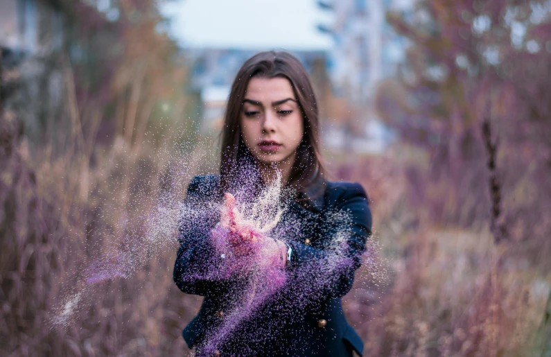 woman with sprinkles in her hands outside