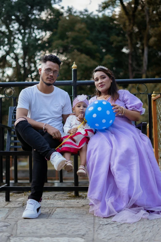 there are two people sitting on the bench posing for a picture