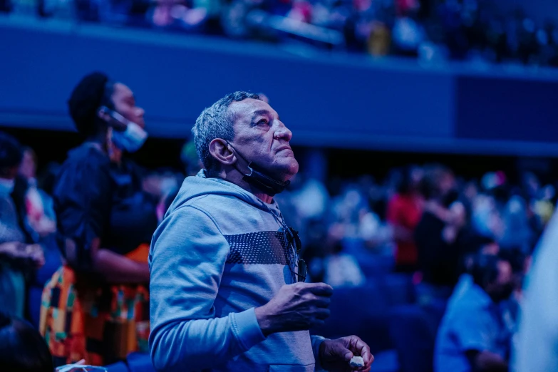 a man standing in front of a crowd at a convention