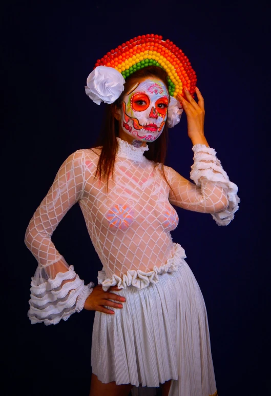 girl with rainbow painted face and hair in white dress