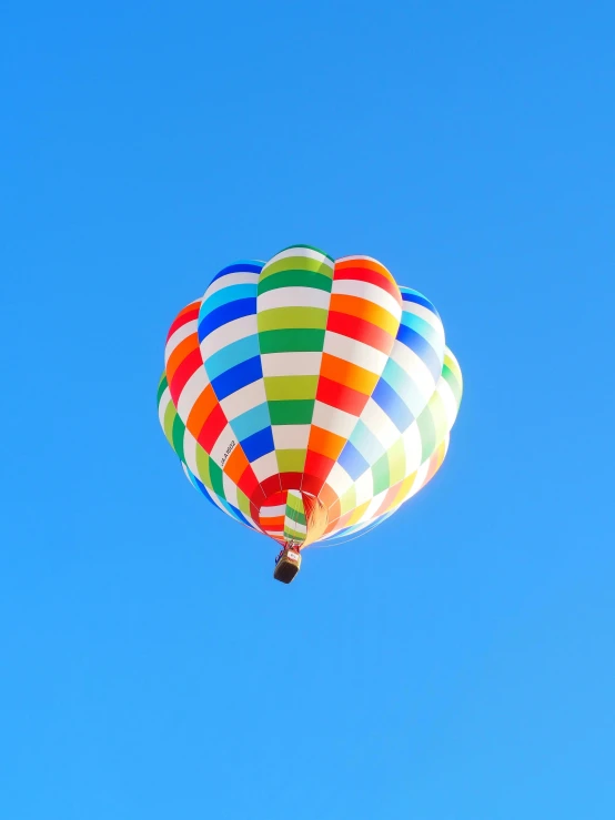 the colorful  air balloon is flying in the sky