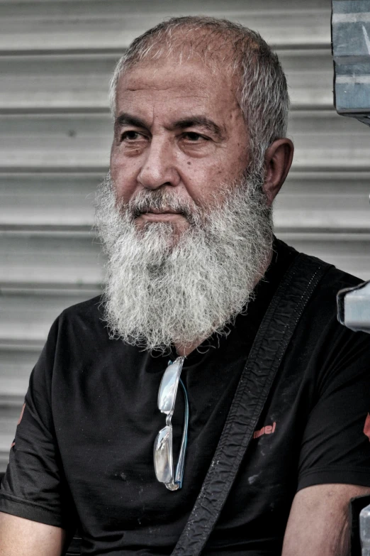 a man with a long white beard wearing a black shirt