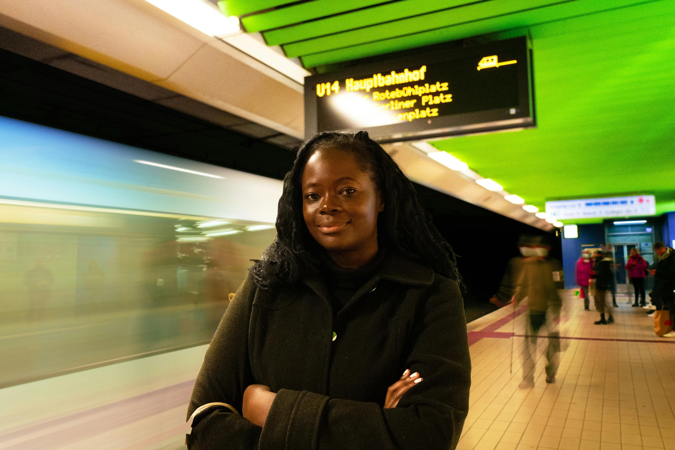 a young lady standing by a subway station