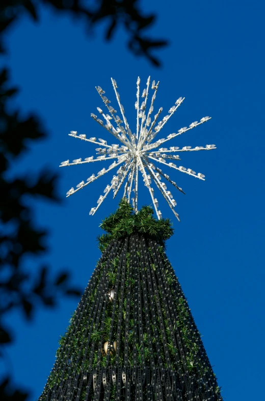 the top of a tower with lights and trees on it
