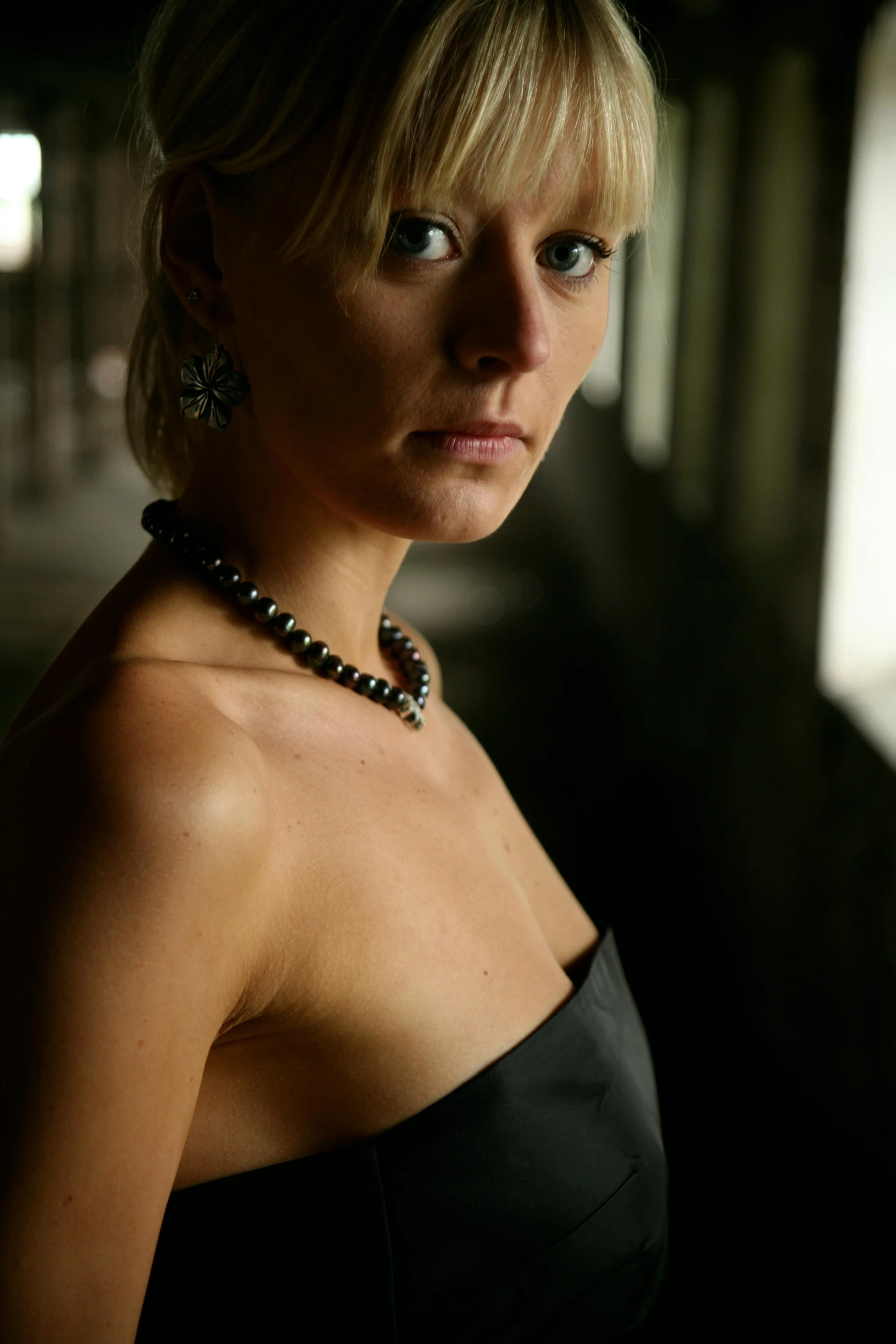 a blonde woman in a black dress posing for the camera