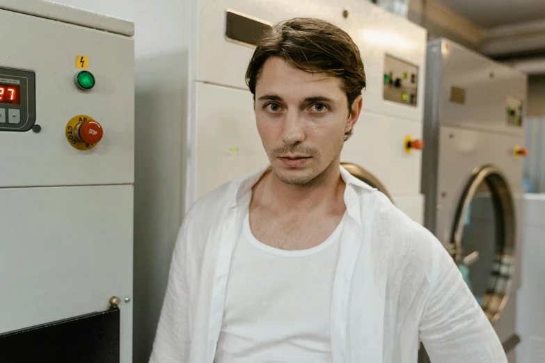 a man standing in front of a oven next to a wall