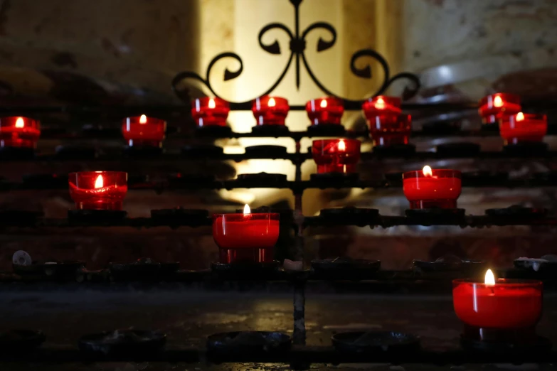 many red candles with some lit inside