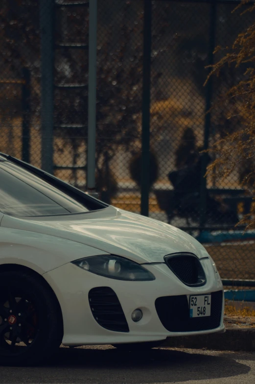 white car with chrome trim parked in the parking lot