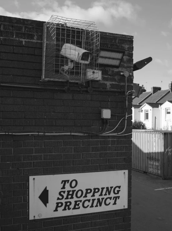 a sign saying to shop precision on a brick wall