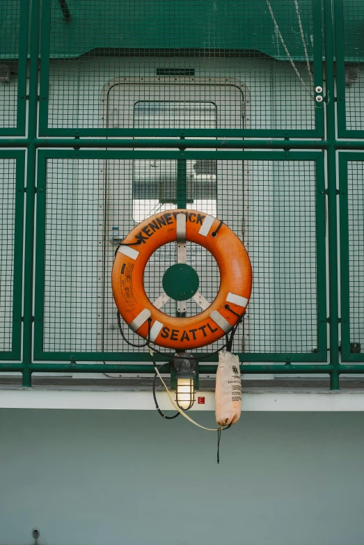 a life preserver hanging off a wire fence