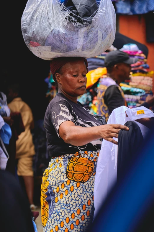 the woman with the bag on her head is shopping