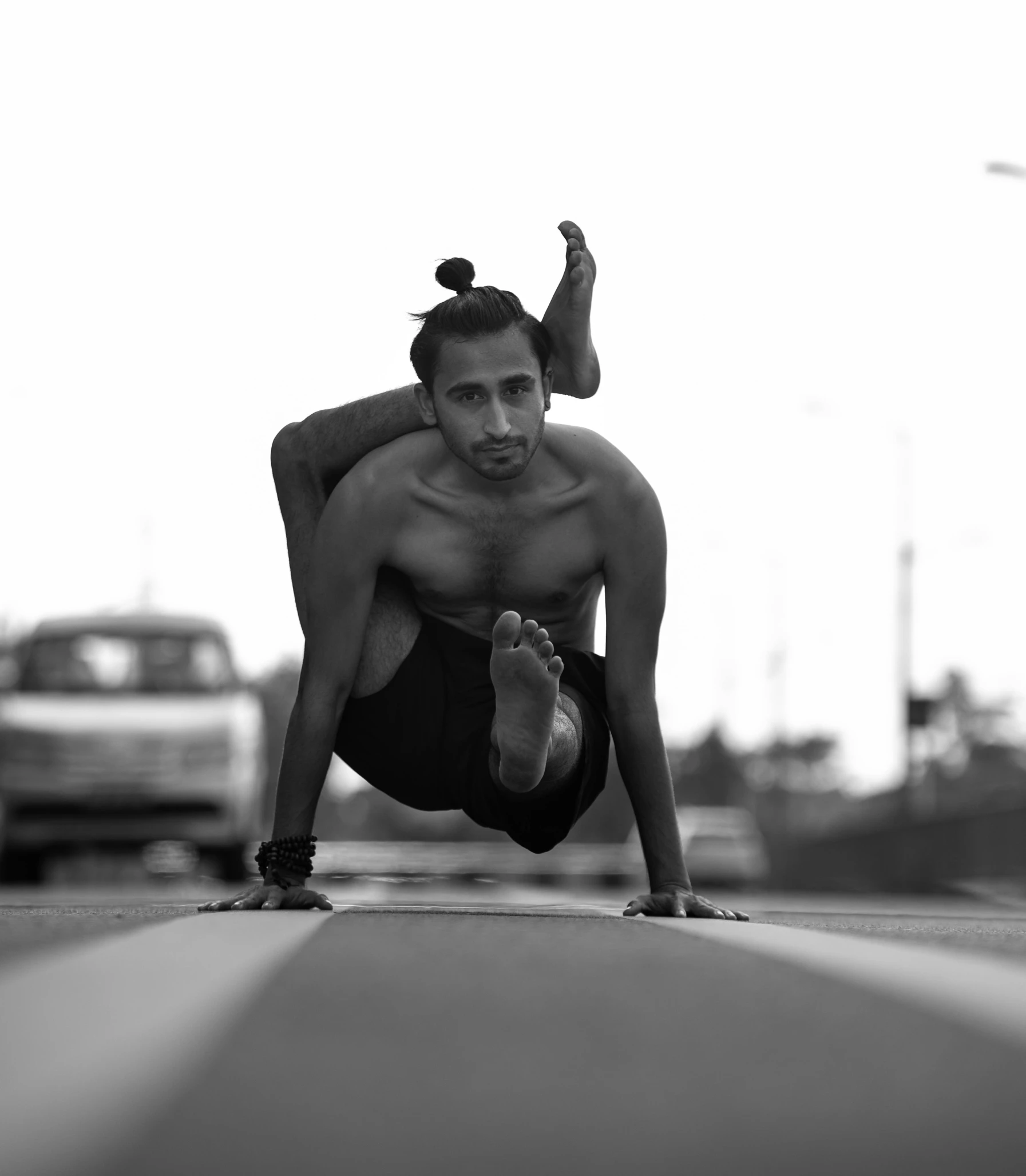 the man is practicing yoga in his underwear