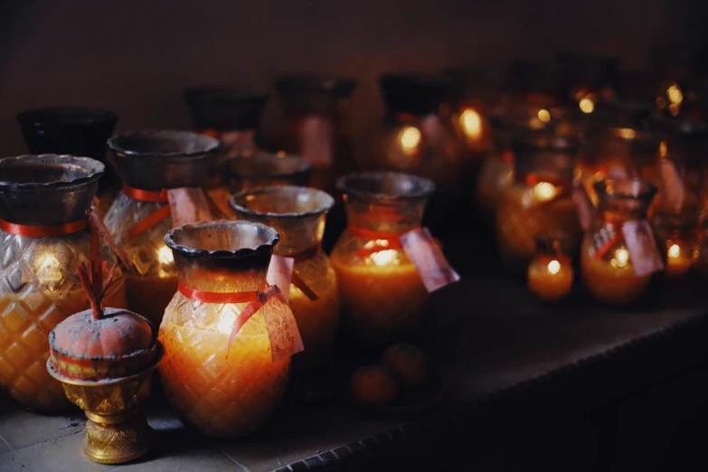 a table topped with lots of yellow candles