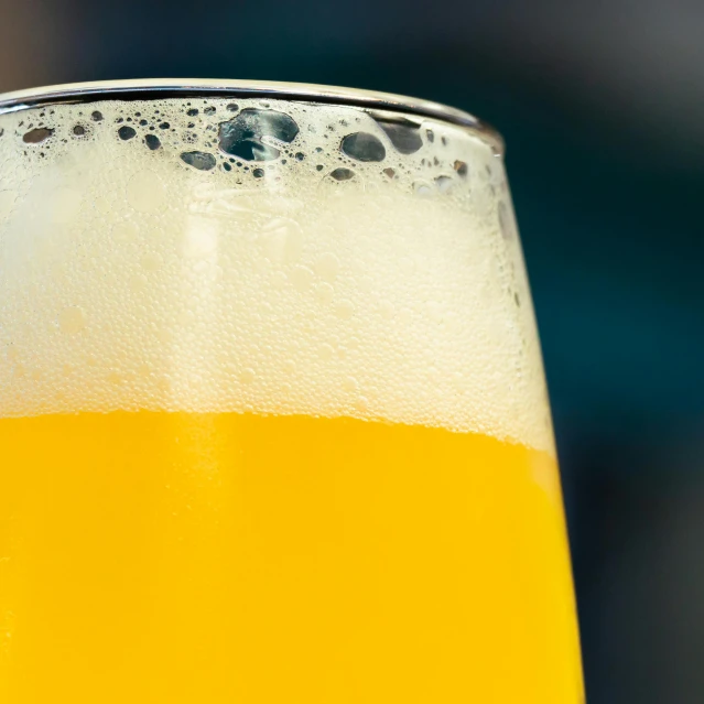 an orange juice is in the bottom of a beer glass