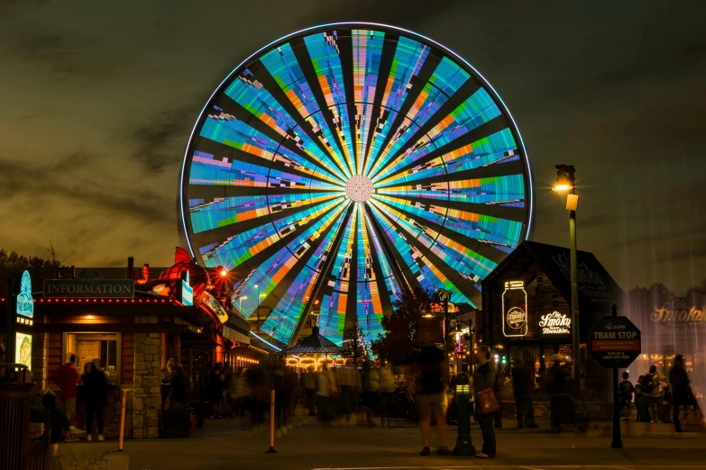 a ferris wheel with bright lights in the sky