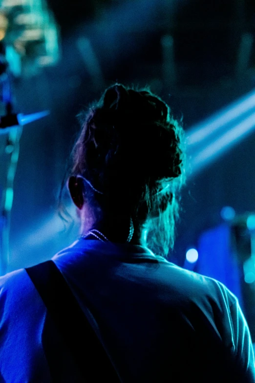 a woman in a black top with blue lights