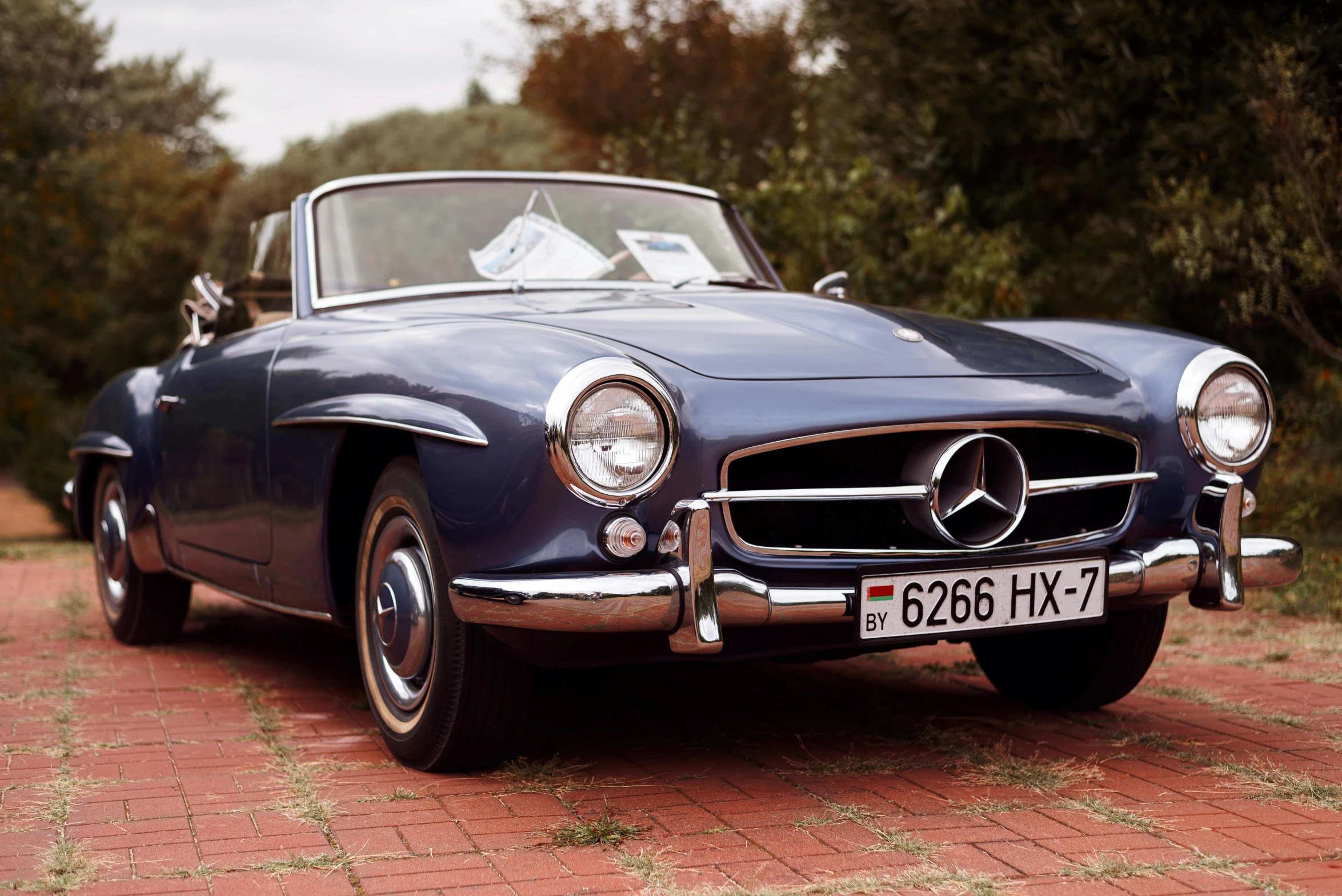 an old fashioned mercedes benz car with the license plate in front