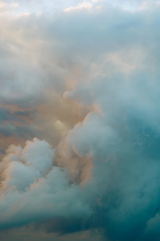 a plane flying under an open sky at dusk